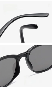 Detail of ergonomic curved temples and integrated nose pads on black foldable sunglasses