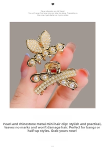 Detailed close-up of mini gold alloy hair claw clips with pearls and rhinestones