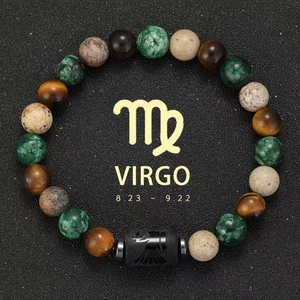 Macro detail of Virgo zodiac bracelet with tiger eye stones on black textured surface
