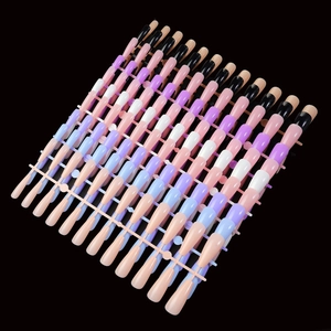 Macro display of colorful press-on nails in various shades on a professional salon frame