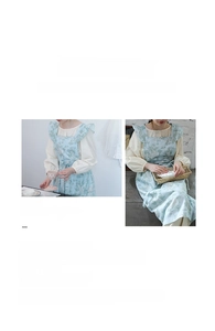 Detail of light blue Mori apron featuring vintage floral prints and elegant ruffle straps