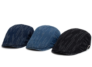 Detail of vintage denim ivy caps with stitching texture and silver metal side buckles