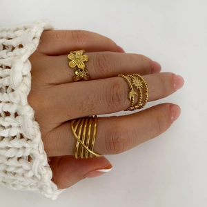 Three-piece gold plated stainless steel ring set with floral and geometric open designs