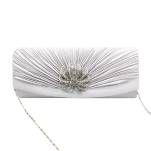Detail of silver satin clutch with pleated design and centered rhinestone flower accent