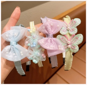 Detail of four colorful lace bow headbands with pearls for girls and women