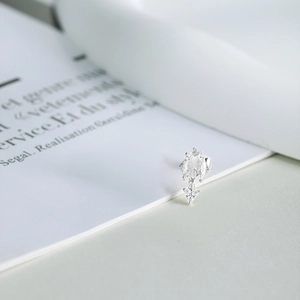 Macro detail of S925 sterling silver flower earring with oval diamond and claw setting