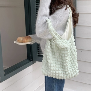 Chic light green bubble cloud texture shoulder tote bag shown in a lifestyle scene
