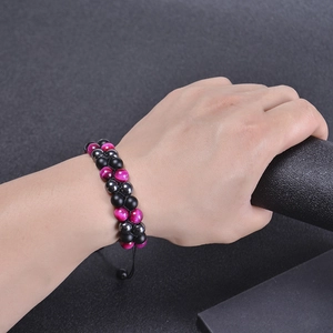 Double-layered braided bracelet with pink tiger eye, matte black beads and adjustable cord