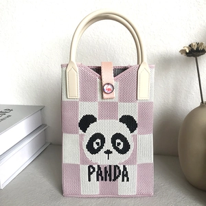 Close-up of pink checkered knit phone bag featuring a black and white panda pattern