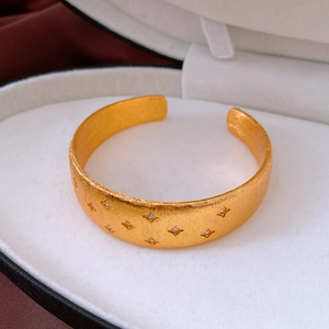 Detail of 18k gold plated star bracelet with cubic zirconia in a jewelry box