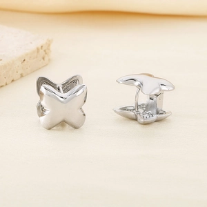 Detailed view of silver butterfly ear buckles with polished mirror finish on stones