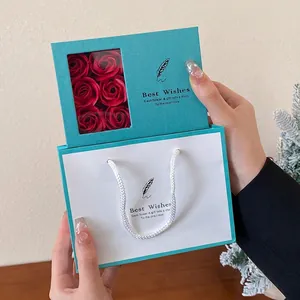 Elegant gift set featuring a teal flower box with red roses and matching white handbag