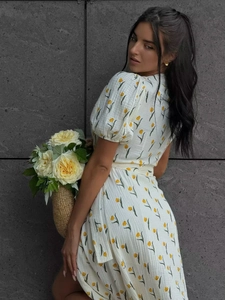 Detail of yellow tulip print and textured cotton fabric on a French puff sleeve dress