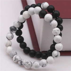 Detail of natural volcanic stone and white turquoise beaded bracelets in a gift box