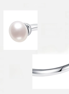 Detail of 925 sterling silver hallmark and glossy natural freshwater pearl on ring