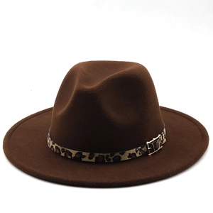 Detail of dark brown wide brim fedora hat with leopard print band and gold buckle