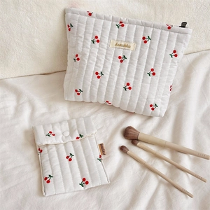 Quilted cotton cherry print makeup bags in large and small sizes with cosmetic brushes