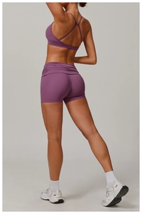 Back view of purple cross-back sports bra and high-waist lifting shorts set