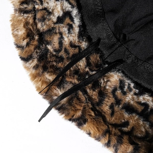 Close-up of leopard faux fur bucket hat featuring soft texture and adjustable black ribbon