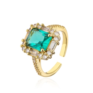 Macro view of 18K gold plated ring featuring a square green zircon with white stone halo