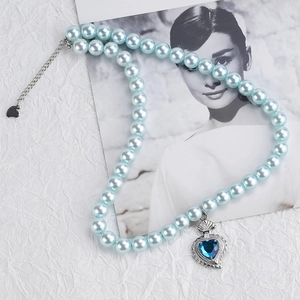 Sky blue pearl necklace featuring a vintage blue heart gemstone pendant with silver chain