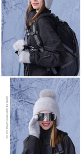 Detail of light gray winter knitted hat with faux fur pompom and matching mittens set