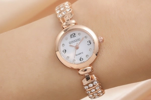 Detail of rose gold women's watch with rhinestone bracelet showing the dial and wrist fit