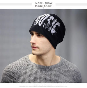 Detail of black cotton beanie showing white MUSIC street style graphic on the front
