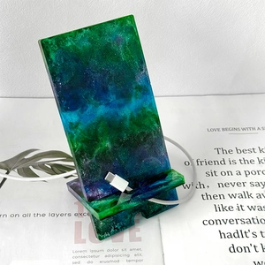 Detail of DIY epoxy resin phone stand with nebula color gradient and charging slot