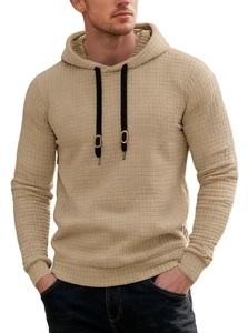 Detail of men's beige waffle knit hoodie showing fabric texture and black drawstring