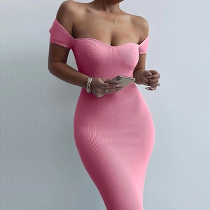Detail of pink ribbed knit off-shoulder dress showing texture and slim-fit tailoring
