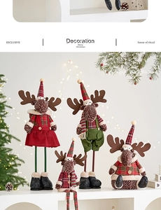Detail of four Christmas reindeer plush dolls in plaid outfits on a festive shelf