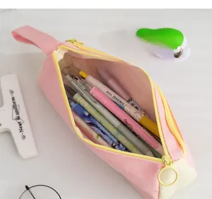 Detailed view of pink canvas pencil pouch with large capacity and yellow zipper design