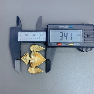 Macro view of gold-plated heart wings ring measured at 34.1 mm with digital calipers