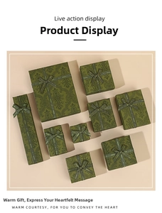 Detail of vintage green gift boxes with floral patterns and 'Best Wishes' ribbons