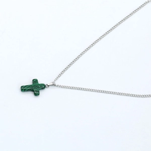Green malachite cross pendant necklace with a polished silver-tone chain on white background