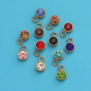 Detailed collection of twelve colorful round birthstone charms with rose gold settings