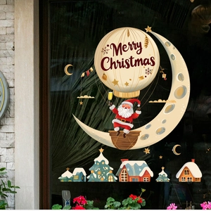 Christmas window stickers with Santa, moon, and hot air balloon on reflective glass