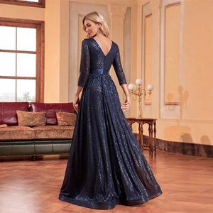 Elegant navy blue sequined evening gown with open back and three-quarter sleeves