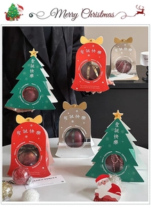 Detailed view of Christmas tree and bell shaped gift boxes with transparent windows