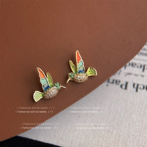 Exquisite gold hummingbird stud earrings with colorful enamel and sparkling zircon stones