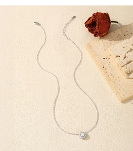 Close-up of elegant S925 silver necklace with sparkling D-color moissanite halo pendant