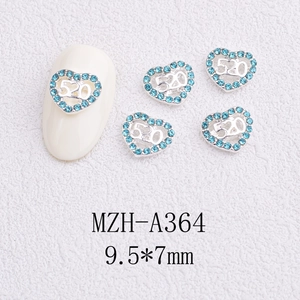 Macro shot of silver heart nail art charm with blue crystals and 520 engraving