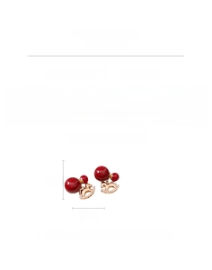 Detail view of 18K gold-plated earring with red ball and zircon-encrusted horse pendant