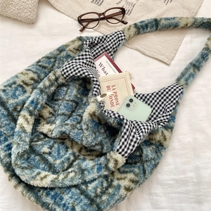 Detailed close-up of plush tote bag interior featuring vintage black and white gingham lining