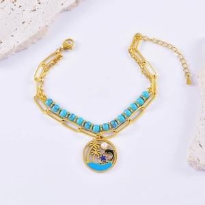 Double-layer gold bracelet with blue beads, ocean pendants, palm tree and dolphin charms