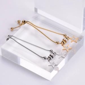 Adjustable 18k gold and silver star charm bracelets with shimmering inlaid crystals