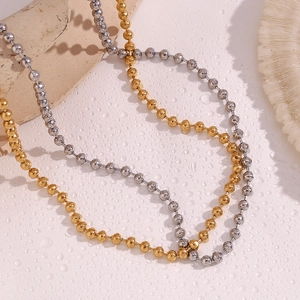 Detail of 4mm faceted bead chain necklaces in 18K gold and silver finishes