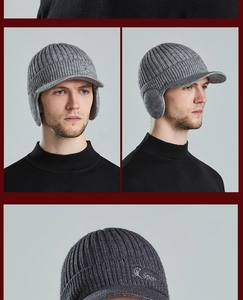 Detail of grey men's winter knit hat featuring ear flaps and embroidered Sport logo