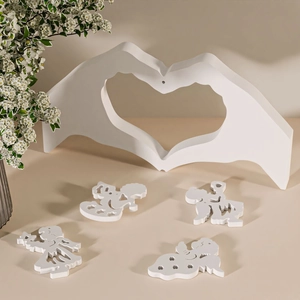 Detail of white heart gesture stand and angel silhouette ornaments for DIY home decor